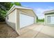 Detached one car garage with siding and concrete driveway at 6811 S Clermont Dr, Centennial, CO 80122
