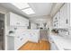 Spacious kitchen with modern white appliances and a view to the cozy living room fireplace at 6811 S Clermont Dr, Centennial, CO 80122