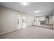 Bright living room with open floor plan, modern lighting and a view to the rear sunroom at 6811 S Clermont Dr, Centennial, CO 80122