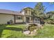 Serene backyard oasis featuring a deck, pond, and lush greenery, perfect for relaxation at 10365 E Weaver Cir, Englewood, CO 80111