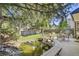 Outdoor deck area with pond, seating, grill, and well-maintained lawn surrounded by mature trees at 10365 E Weaver Cir, Englewood, CO 80111