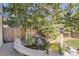 Close-up view of a backyard pond with rock features, lush foliage, and a small waterfall feature at 10365 E Weaver Cir, Englewood, CO 80111