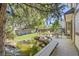 Inviting backyard featuring a pond with a waterfall, a deck, and ample seating for outdoor enjoyment at 10365 E Weaver Cir, Englewood, CO 80111