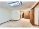 Spacious basement with neutral carpet, wood trim, and access to the upper level at 10365 E Weaver Cir, Englewood, CO 80111
