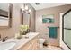 A full bathroom features double vanity with granite countertop and decorative mirror and includes a bath and shower combo at 10365 E Weaver Cir, Englewood, CO 80111