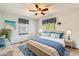 This bedroom features neutral walls, patterned window coverings, and coordinating throw pillows and decor for a relaxing vibe at 10365 E Weaver Cir, Englewood, CO 80111