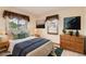 Cozy bedroom with neutral walls, patterned window coverings and coordinating linens and decor for a comfortable retreat at 10365 E Weaver Cir, Englewood, CO 80111