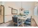 An elegant dining room with a chandelier, bright natural light and seating for six at 10365 E Weaver Cir, Englewood, CO 80111