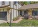 Close-up of charming home featuring brick accents, tidy landscaping, and an inviting front entrance at 10365 E Weaver Cir, Englewood, CO 80111