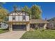 Charming Tudor-style home with well-maintained lawn and a two-car garage in a suburban neighborhood at 10365 E Weaver Cir, Englewood, CO 80111