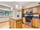 Bright kitchen featuring stainless steel appliances, wood cabinets and a center island at 10365 E Weaver Cir, Englewood, CO 80111