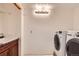 Well-equipped laundry room with modern washer and dryer, sink, and storage at 10365 E Weaver Cir, Englewood, CO 80111