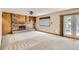 Spacious living room with brick fireplace, built-in shelves and hardwood floors at 10365 E Weaver Cir, Englewood, CO 80111