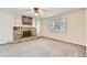 Bright living room with a brick fireplace, built-in shelves, and a ceiling fan at 10365 E Weaver Cir, Englewood, CO 80111