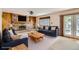 A living room featuring a brick fireplace, hardwood floors and plenty of light at 10365 E Weaver Cir, Englewood, CO 80111