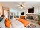 Spacious main bedroom featuring a brick fireplace, ceiling fan, and ample natural light at 10365 E Weaver Cir, Englewood, CO 80111