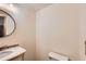 Chic powder room featuring a stylish vanity, decorative mirror, and modern toilet at 10365 E Weaver Cir, Englewood, CO 80111