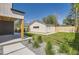 Landscaped backyard features a modern garage, stylish patio, and lush green grass at 1880 S Adams St, Denver, CO 80210