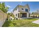 Modern two-story home boasts a covered patio and well-manicured lawn with a detached garage at 1880 S Adams St, Denver, CO 80210