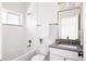 Bright bathroom featuring white tile, classic fixtures, and a vanity with grey counter at 1880 S Adams St, Denver, CO 80210
