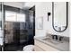 Modern bathroom featuring a tiled walk-in shower with glass enclosure and sleek vanity at 1880 S Adams St, Denver, CO 80210