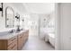 Large bathroom with double vanity, framed mirrors, and glass enclosed shower and tub at 1880 S Adams St, Denver, CO 80210