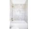 Modern bathroom with tiled walls, soaking tub, and bronze shower fixtures at 1880 S Adams St, Denver, CO 80210