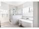 Bright bathroom features a soaking tub and glass enclosed walk-in shower at 1880 S Adams St, Denver, CO 80210