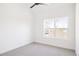 Clean bedroom with bright white walls, ceiling fan, and large window at 1880 S Adams St, Denver, CO 80210