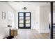 Bright entryway with large front door, light wood floors, and stylish decor at 1880 S Adams St, Denver, CO 80210