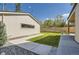 Garage exterior features modern siding, a black-trimmed window, and access to backyard at 1880 S Adams St, Denver, CO 80210