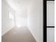 Clean and bright hallway with neutral carpet and adjacent powder room at 1880 S Adams St, Denver, CO 80210
