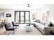 Living room with comfortable seating, a modern ceiling fan, and access to backyard at 1880 S Adams St, Denver, CO 80210