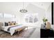 Bright main bedroom with vaulted ceiling, bench, large windows, and decorative chandelier at 1880 S Adams St, Denver, CO 80210