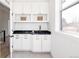 Mud room features cabinets with storage, black counters, and stylish finishes at 1880 S Adams St, Denver, CO 80210
