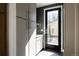Mudroom features cabinetry, countertop space, and exterior door with access to backyard at 1880 S Adams St, Denver, CO 80210