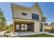 Back of the house features a covered patio, modern design, and access to the backyard at 1880 S Adams St, Denver, CO 80210