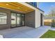 Covered patio with wood ceiling, modern doors, access to backyard, and brick and siding exterior at 1880 S Adams St, Denver, CO 80210