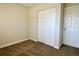 Bedroom with double door closet and carpet flooring at 13030 E Kansas Pl, Aurora, CO 80012