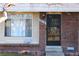 Front door and entrance to a brick townhouse at 13030 E Kansas Pl, Aurora, CO 80012