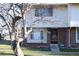 Brick townhouse exterior with a front door and landscaping at 13030 E Kansas Pl, Aurora, CO 80012