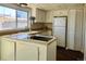 Kitchen with white cabinets, gas cooktop, and pantry at 13030 E Kansas Pl, Aurora, CO 80012