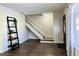 Living room with hardwood floors, staircase, and decorative shelving at 13030 E Kansas Pl, Aurora, CO 80012