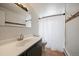 Bathroom featuring tile flooring, vanity, mirror, toilet, and shower with shower curtain at 6048 Xenon St, Arvada, CO 80004