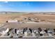 A beautiful aerial view shows neighborhood homes, adjacent farmland, and the neighborhood layout at 2303 Angus St, Mead, CO 80542
