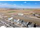 A beautiful aerial view shows neighborhood homes, adjacent farmland, and stunning mountain views at 2303 Angus St, Mead, CO 80542