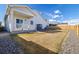 Well-maintained backyard features green grass, rock landscaping, and a charming covered patio at 2303 Angus St, Mead, CO 80542