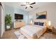 Stylized bedroom with a ceiling fan, a TV, a window, and a queen size bed at 2303 Angus St, Mead, CO 80542