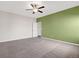 Spacious bedroom featuring neutral carpet, ceiling fan, and a unique accent wall at 2303 Angus St, Mead, CO 80542