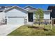 Charming single-Gathering home with light blue siding, a two-car garage, and a well-maintained lawn at 2303 Angus St, Mead, CO 80542
